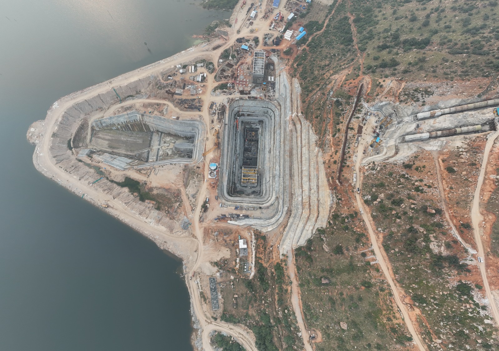 Aerial top view of the PSP Chitravathi powerhouse excavation beside the reservoir